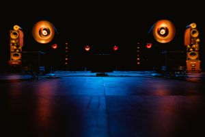 Illuminated speakers on the dark stage.
