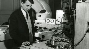 Pierre Schaeffer stands at a tape recorder