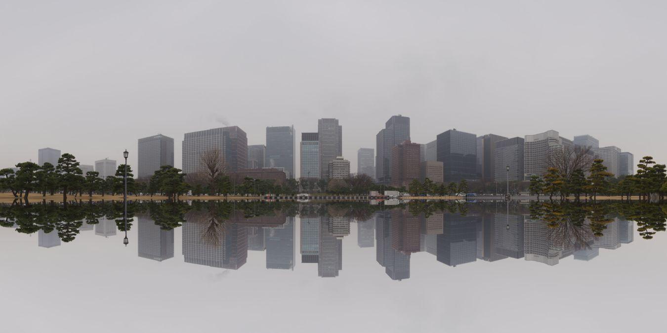 Cityscape with modern skyscrapers reflected in calm water, trees in the foreground.