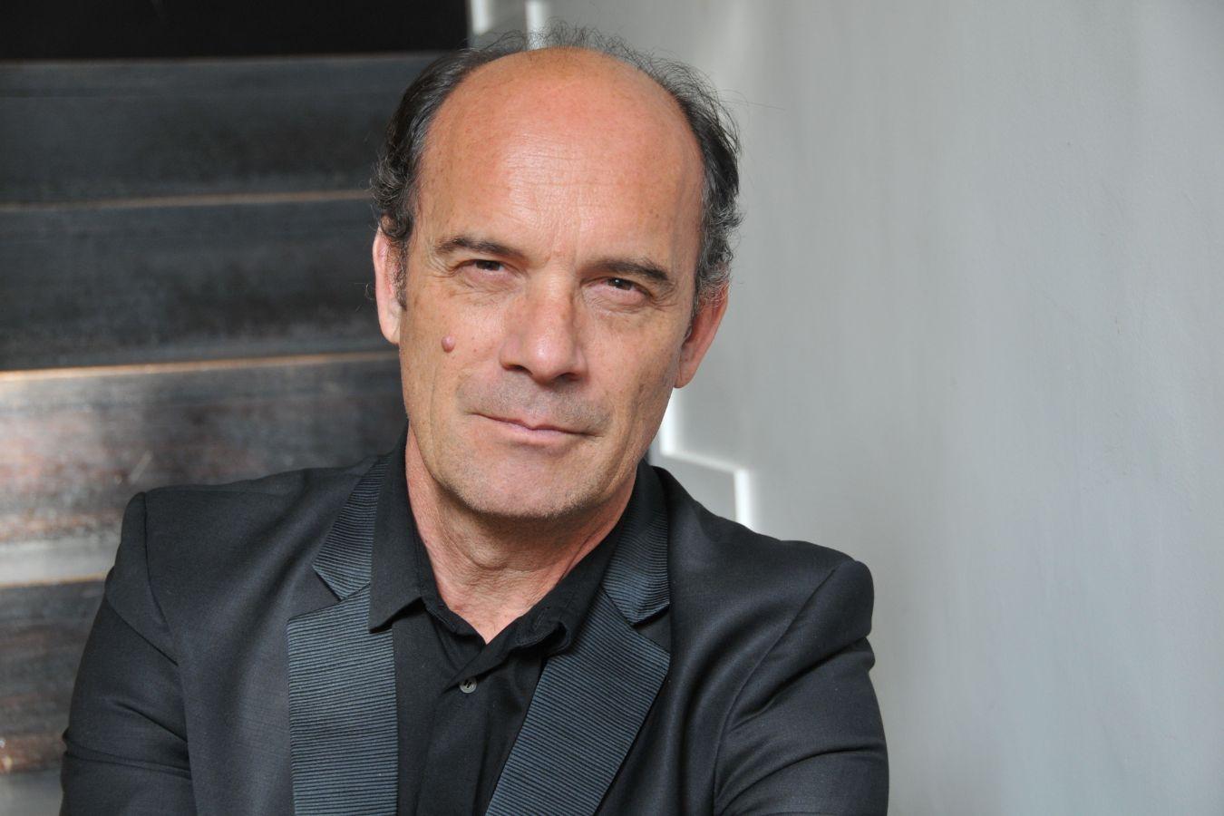 A man looks seriously into the camera.