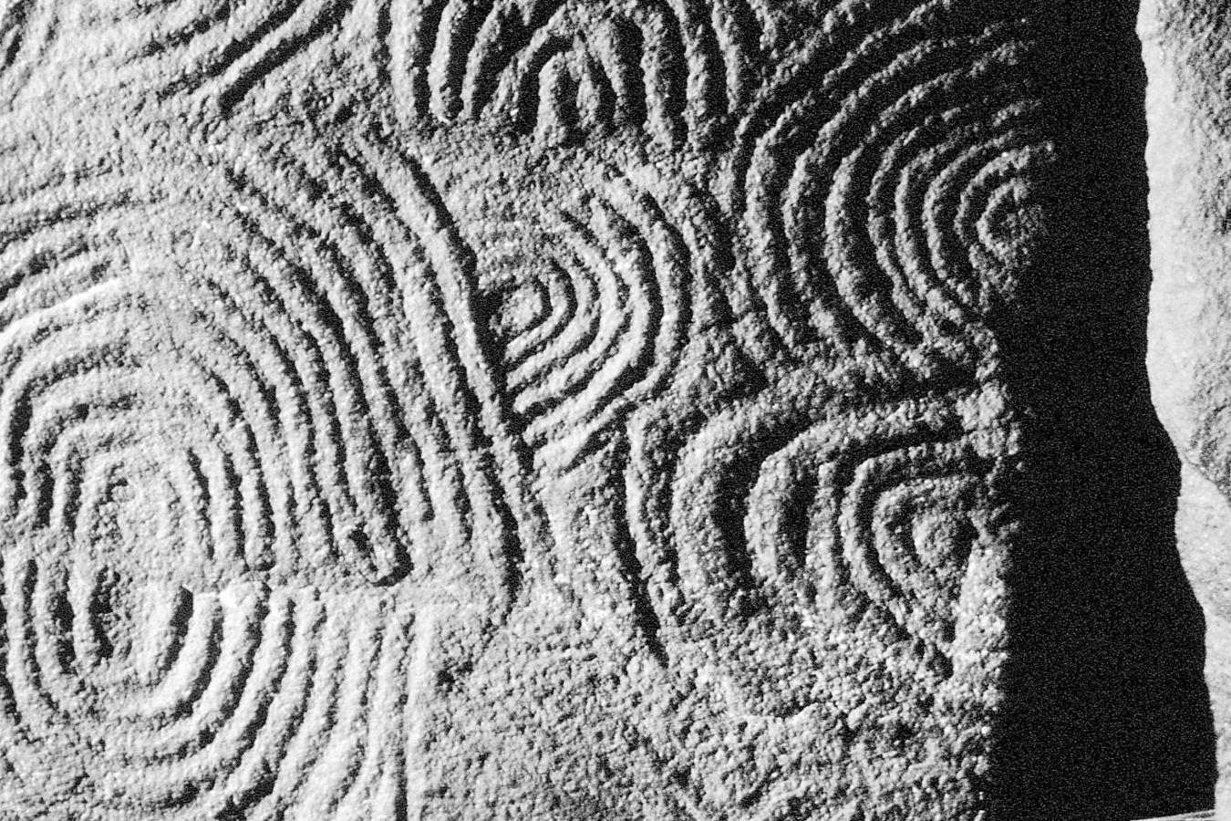 Celtic stone carvings form a high-contrast pattern.