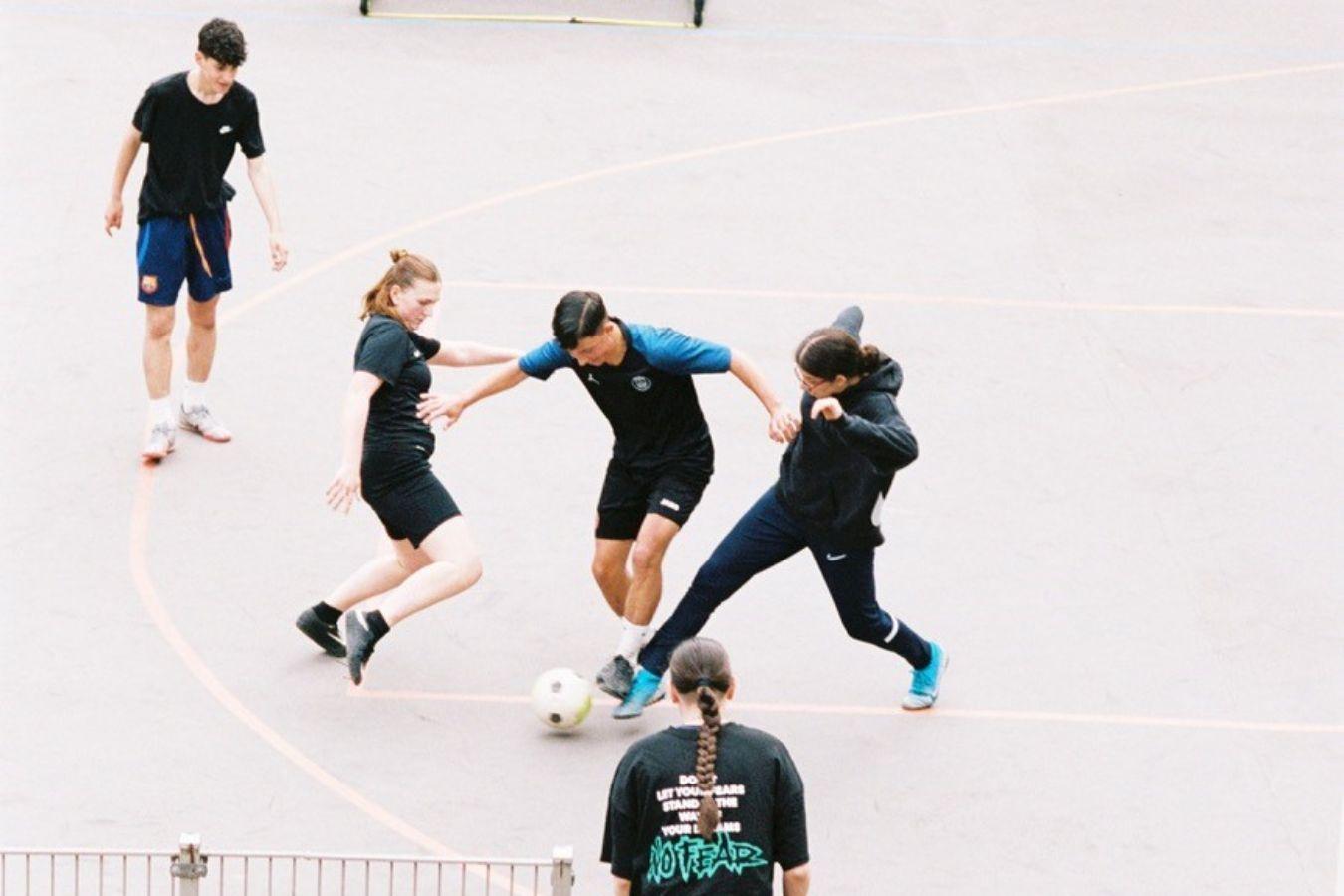 eople are playing soccer indoors.