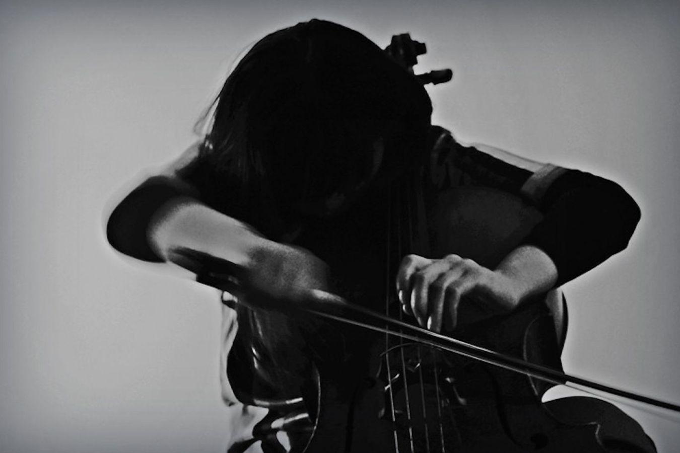 A woman with black hair is sitting on a staircase.