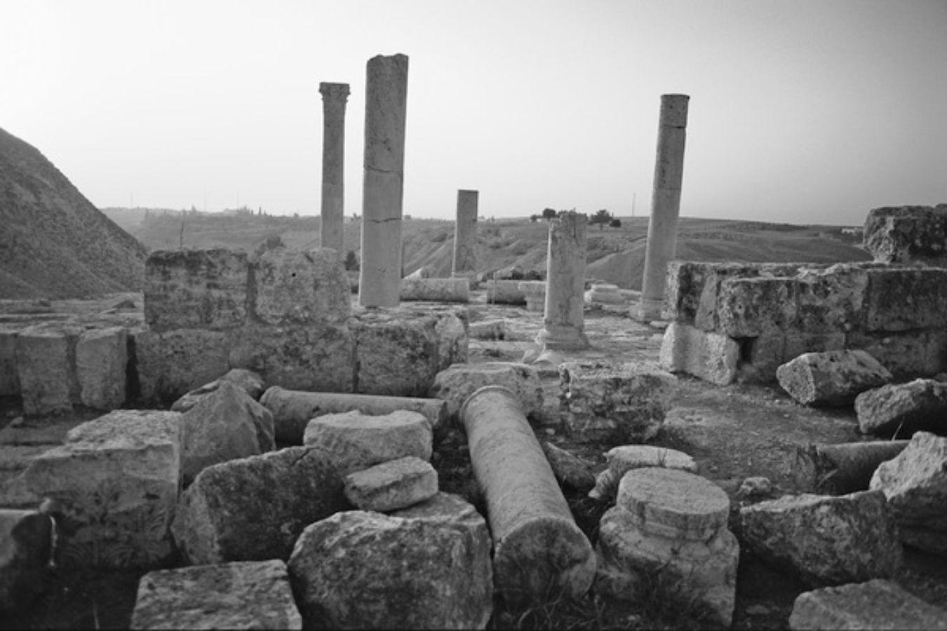 Pillars of a ruined temple rise into the sky.