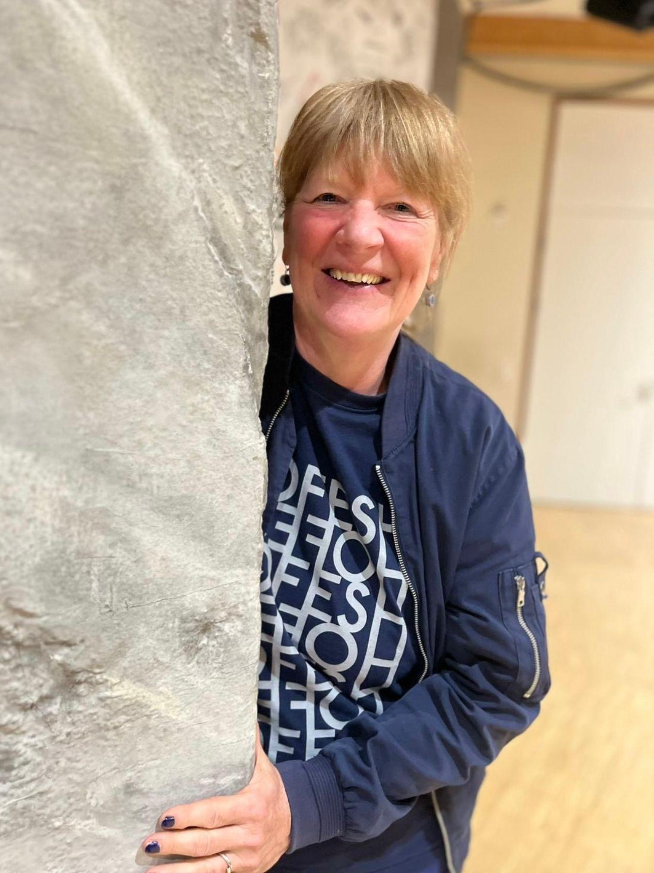 Porträt einer Frau, die in die Kamera lächelt.