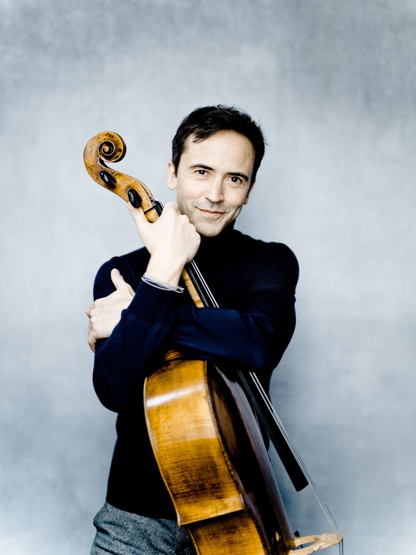 Queyras embraces his cello.