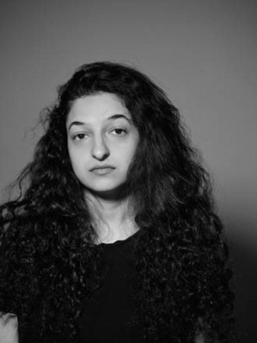 Black-and-white portrait of a woman looking directly at the camera.