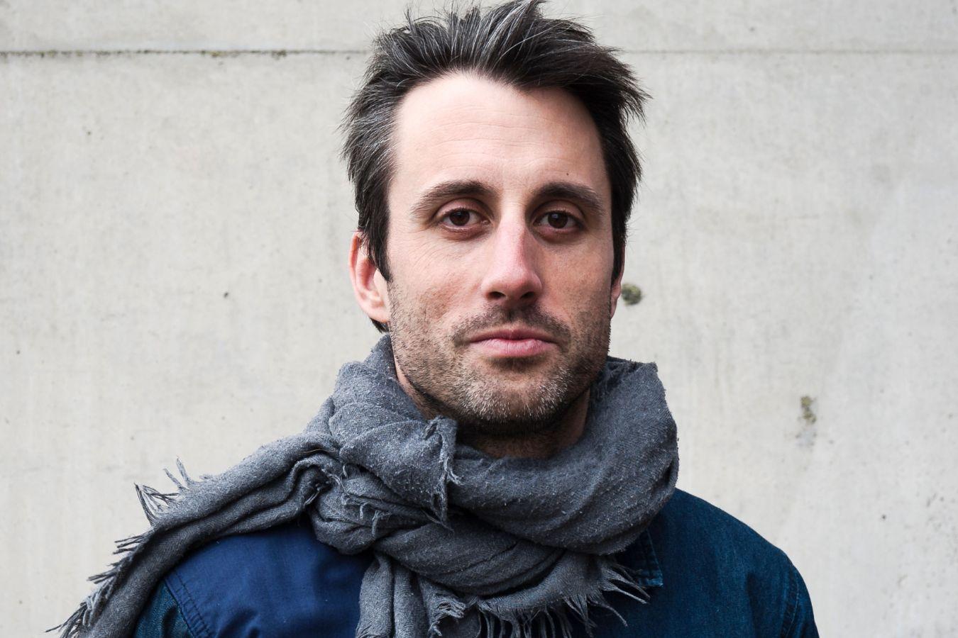 Portrait of Alexander Hawkins looking neutrally into the camera.