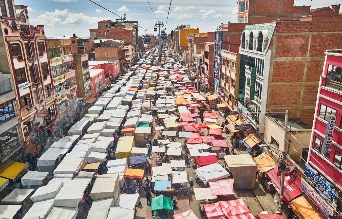 View of a street from above in South America, full of market stalls.
