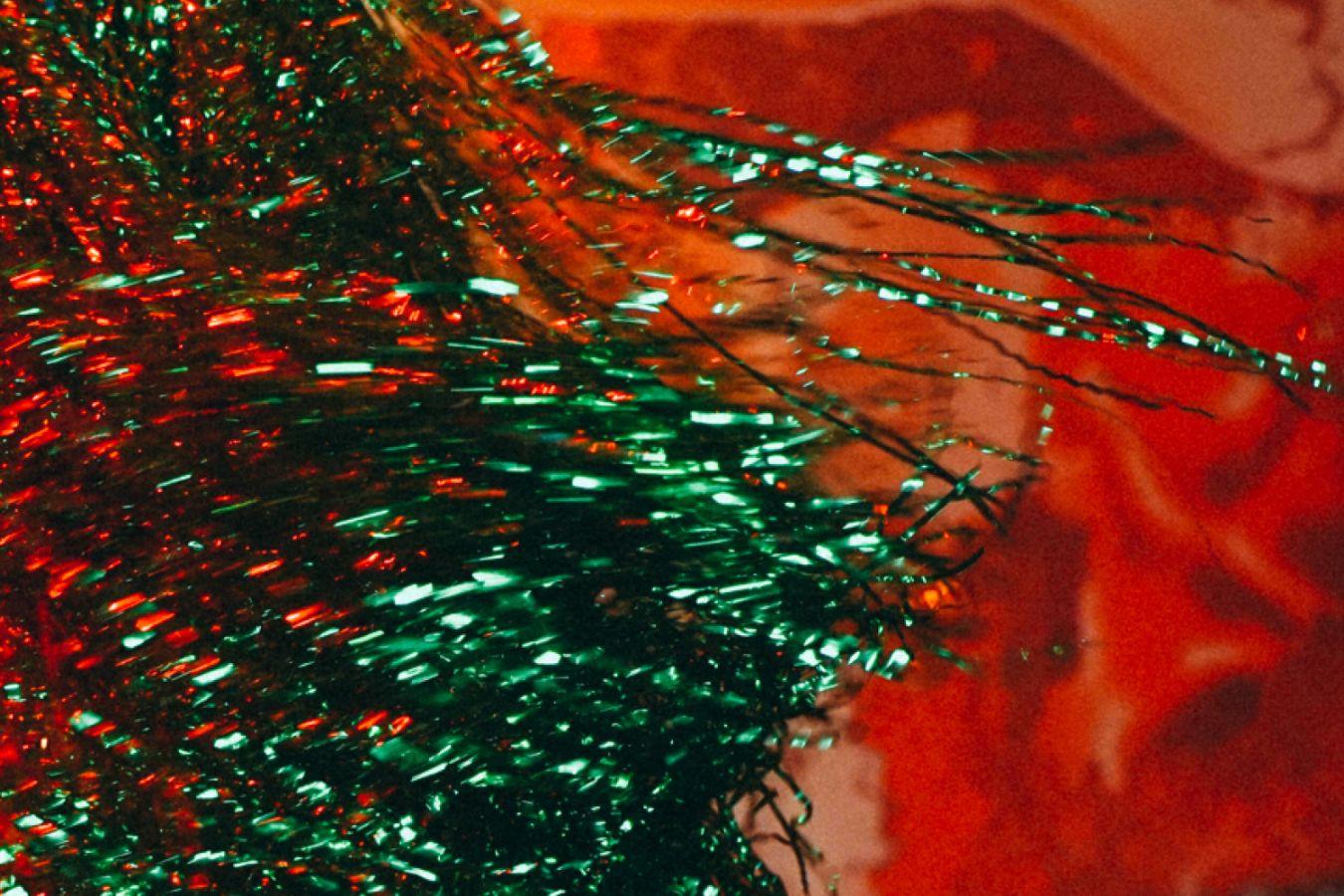 Glitter wig against an orange background