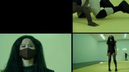 Split screen divided into four sections, each showing a female-presenting person from different angles in a yellowish-green room. The person looks in various directions, with slightly different postures.