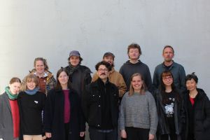 Group photo of the twelve ensemble members in their own clothes.