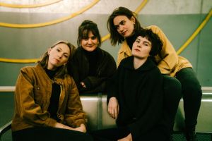 Four women on a metal bench