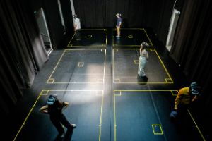 Five people with VR goggles stand in a room.