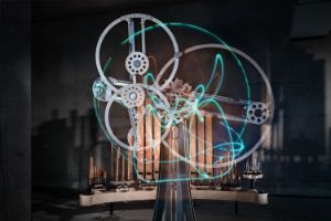 A technical installation with light trails between the wheels, organ pipes in the background.