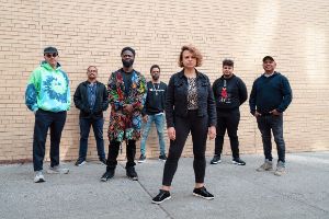 Gruppenfoto: Das Patricia Brennan Septet steht auf einem betonierten Platz vor einer Mauer.