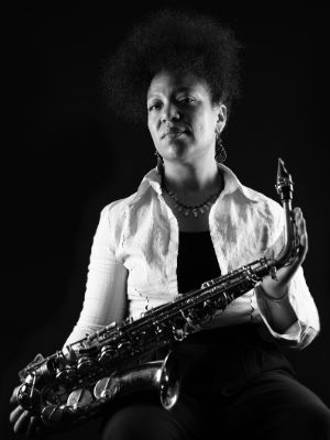 Schwarz-weiß-Porträt von Sakina Abdou mit Saxofon.