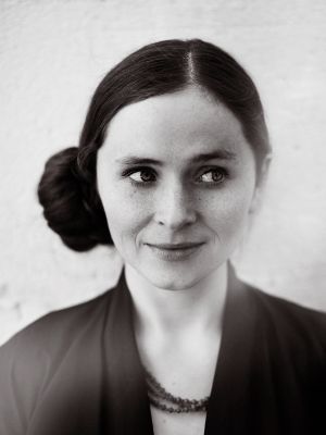 Einarsdóttir schielt nach links und trägt einen strengen seitlichen Dutt.