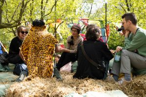 A group of people sitting on bales of straw