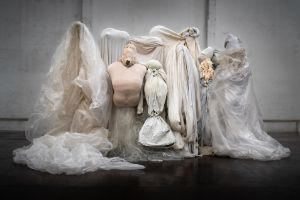 An ensemble of fabrics and plastic tarpaulins reminiscent of human bodies.