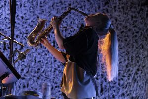 Mette Rasmussen playing expressively on the saxophone.