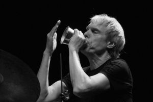 Gerry Hemingway sitting behind a drum kit in the middle of action.