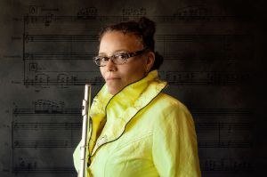 Portrait of Nicole Mitchell holding a flute in her hands.