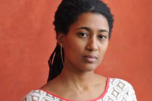 Portrait of Tomeka Reid looking neutrally into the camera.
