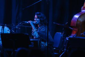 Amirtha Kidambi smiles into a mikrophone