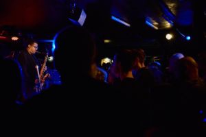 View from the audience onto the stage, where James Brandon is playing the saxophone