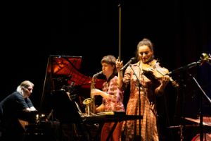Three young female musicians on stage