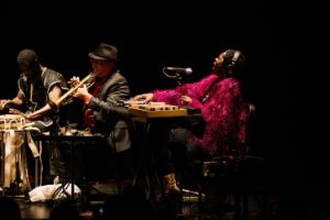 Elsa M'bala wears a bright pink jacket trimmed with tinsel.