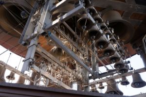 Froschperspektive der Glocken eines Carillonturms, im Hintergrund der blaue Himmel.