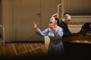 Nadezhda Pavlova stands singing in front of Alexander Melnikov, who plays the grand piano.