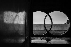 Architectural detail of the concrete building, view from the interior through two interlocking circular openings to the outside.