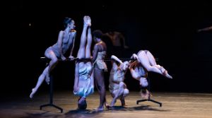 Performers dancing on stage.