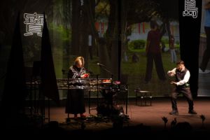 Performers on stage with a backdrop in the background during the performance of "This is not a message (Made in Taiwan)"
