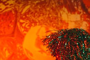 Glitter wig against an orange background