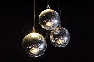 Three dicso balls on a black background