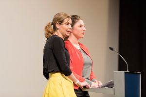 Burning Issues founders Nicola Bramkamp and Lisa Jopt in front of the speaker's podium.