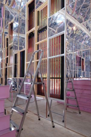 A ladder stands in the mirrored interior of the “Forecast House”.