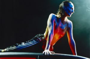 Lying on the roof of a car, a person is supporting themselves with their arms