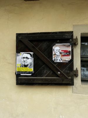 A wooden shutter covered with posters