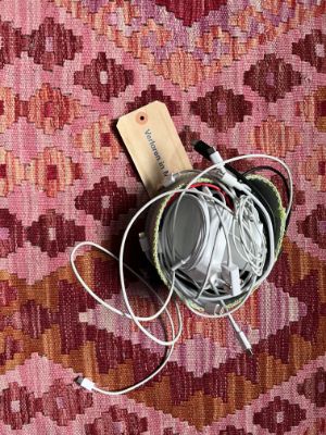 A collection of power plugs in a bright green basket
