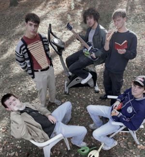 The five members of the Astranauts sit on chairs and look up into the camera.