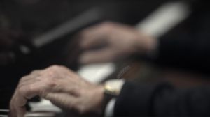 Zwei Hände liegen auf einem Klavier
